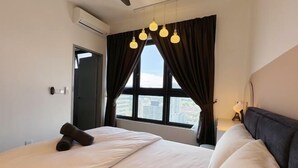 A hotel room with a bed, a window with curtains, a ceiling fan, and a view of the city. - M Vertica KL City 4 Bedroom Fully Air-Con Suite (Kuala Lumpur)