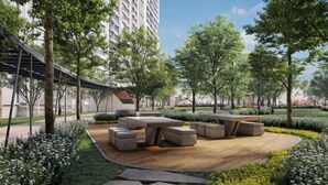 A landscaped outdoor area with a wooden deck, seating, and trees. - M Vertica KL City 4 Bedroom Fully Air-Con Suite (Kuala Lumpur)
