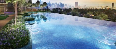 A rooftop infinity pool with a city skyline in the background.