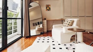 A modern living room with a large window, a sofa, a coffee table, and a mirror. - 4Br Modern Art Villa with Free Wi-Fi Netflix Vinyl (Bangkok)