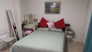 A bedroom with a bed, a dresser, a mirror, a nightstand, and a framed picture on the wall. - Shin Awaji Building II, 202 Heart House,1 minute from Awaji Station. (Osaka)