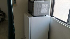 A kitchen with a refrigerator and a microwave on top. - Shin Awaji Building II, 202 Heart House,1 minute from Awaji Station. (Osaka)
