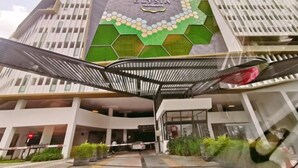 A modern hotel entrance with a distinctive hexagonal mosaic design and a sign reading "The Elysia." - Legoland -3min Drive at Elysia Park @Happy Wonder Stay-8pax(max)-Pool Garden View-Kids Friendly (Iskandar Puteri)