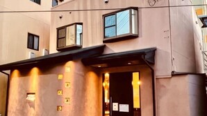 A building with a modern architectural style, featuring a flat roof, large windows, and a prominent entrance with a black awning. - Shirahama no Kaze (Shirahama)