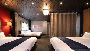 A hotel room with two beds, a desk, a chair, a lamp, and a view of the city. - Shirahama no Kaze (Shirahama)