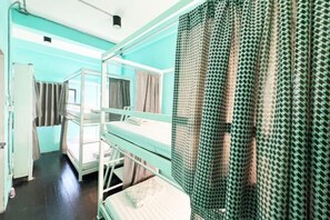 A bunk bed room with a window, a desk, and a patterned curtain. - Dhub Hostel Donmueng (Bangkok)
