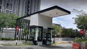 A modern building with a glass entrance, surrounded by greenery and tall residential buildings. - D'sands Residences Midvalley (Kuala Lumpur)
