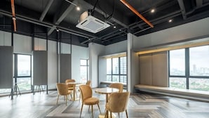 A modern conference room with a large window, a projector, and a herringbone-patterned floor. - Bliss Residence Old Klang Road by FEEL HOME (Kuala Lumpur)