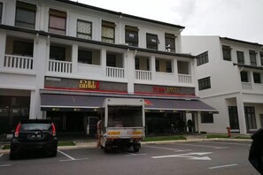 A multi-story building with a storefront featuring signage in a foreign language.