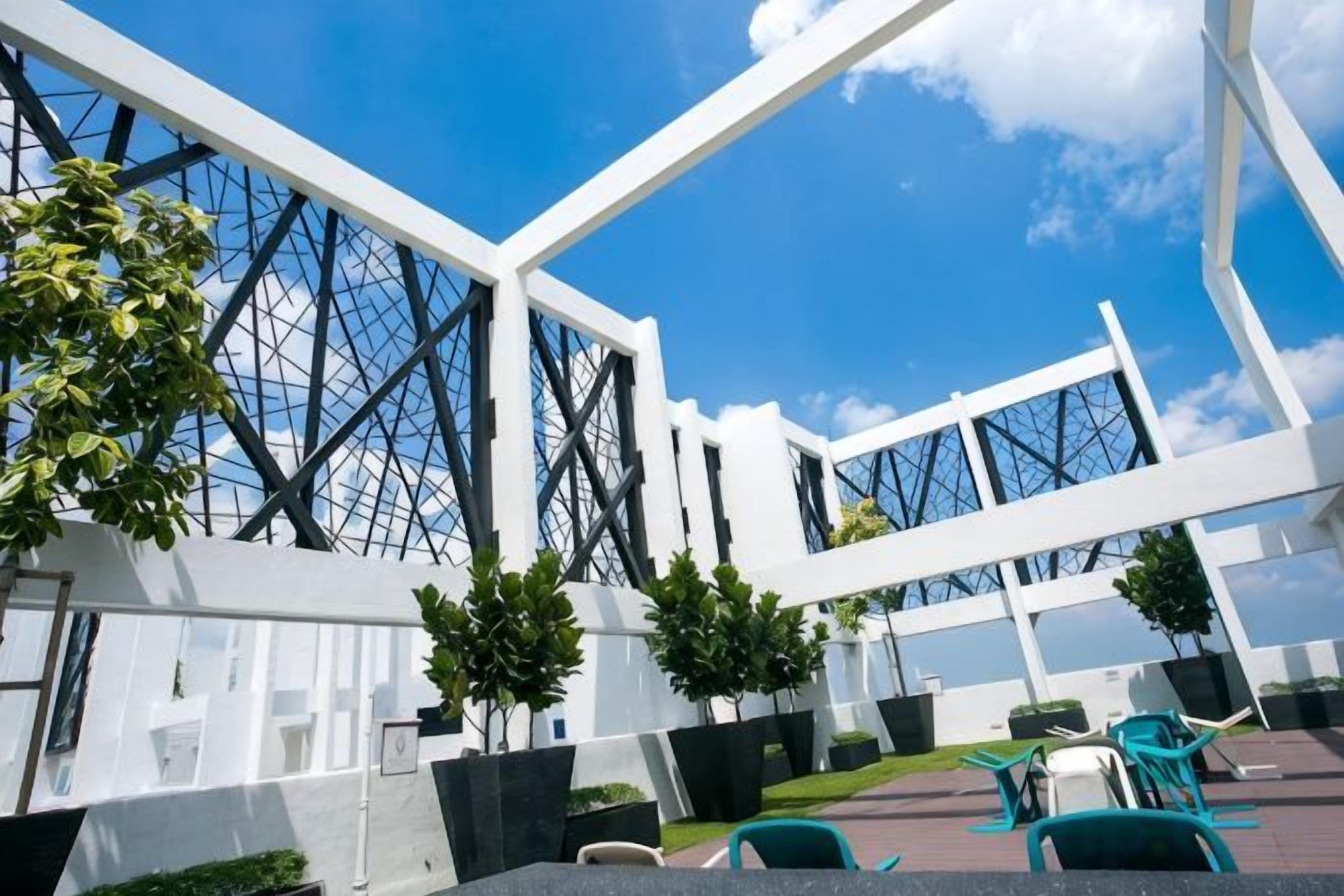 A modern building with a glass facade and white structural elements.
