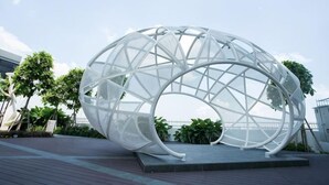 A modern, white, spherical structure with a geometric design, situated on a paved area with trees and a clear sky in the background. - Econest Apartment By The One - Educity Ecobotanic (Gelang Patah)