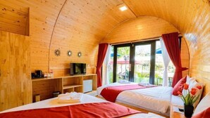 A cozy wooden cabin with two beds, a TV, and a small kitchenette. - Moly Resort (Kampot)