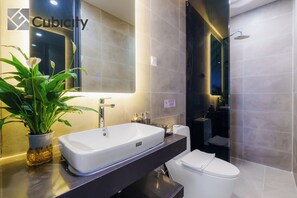 A modern bathroom with a large sink, a toilet, and a shower area. - Cubicity Wall Street House (Ho Chi Minh City)