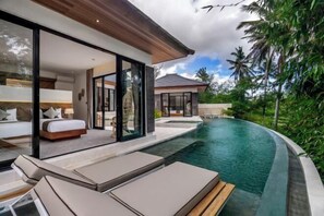 A modern villa with a private pool, a bedroom with a large bed and a sitting area, and a view of the surrounding tropical landscape. - Villa Ganesha by BaliSuperHost (Bali)