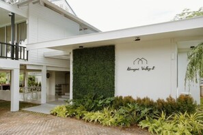 A modern building with a white exterior, a green vertical garden, and a sign that reads 'Kangaroo Valley.' - Khaoyai Valley8 (3BR-max 10 guests) (Pak Chong)