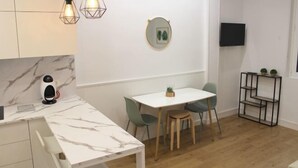 A modern kitchen with marble countertops, a built-in coffee machine, and pendant lighting. - NEW, CENTRAL NEAR BEACH AND SEA by www.SanSebastianApartments.es (San Sebastian)