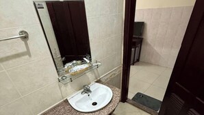 A bathroom with a white sink, a mirror, and a toilet. - OYO 1296 Phu Loc Xuan Hotel Danang (Da Nang)