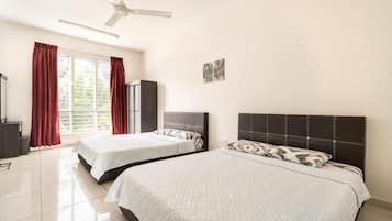 A bedroom with two beds, a ceiling fan, a window with curtains, and a small artwork on the wall.
