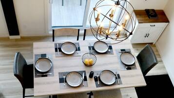 A dining table set with plates, cutlery, and a centerpiece.