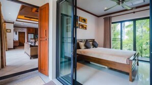 A bedroom with a bed, a sliding glass door, a ceiling fan, and a view of palm trees. - Lotus Pool Villa Your Own Slice Of Island Paradise (Phuket)