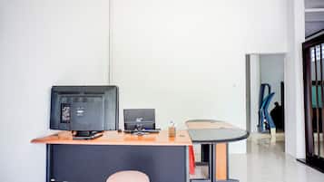 A modern office space with a desk, computer, and chair.