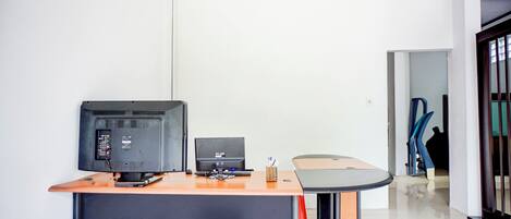 A modern office space with a desk, computer, and chair.