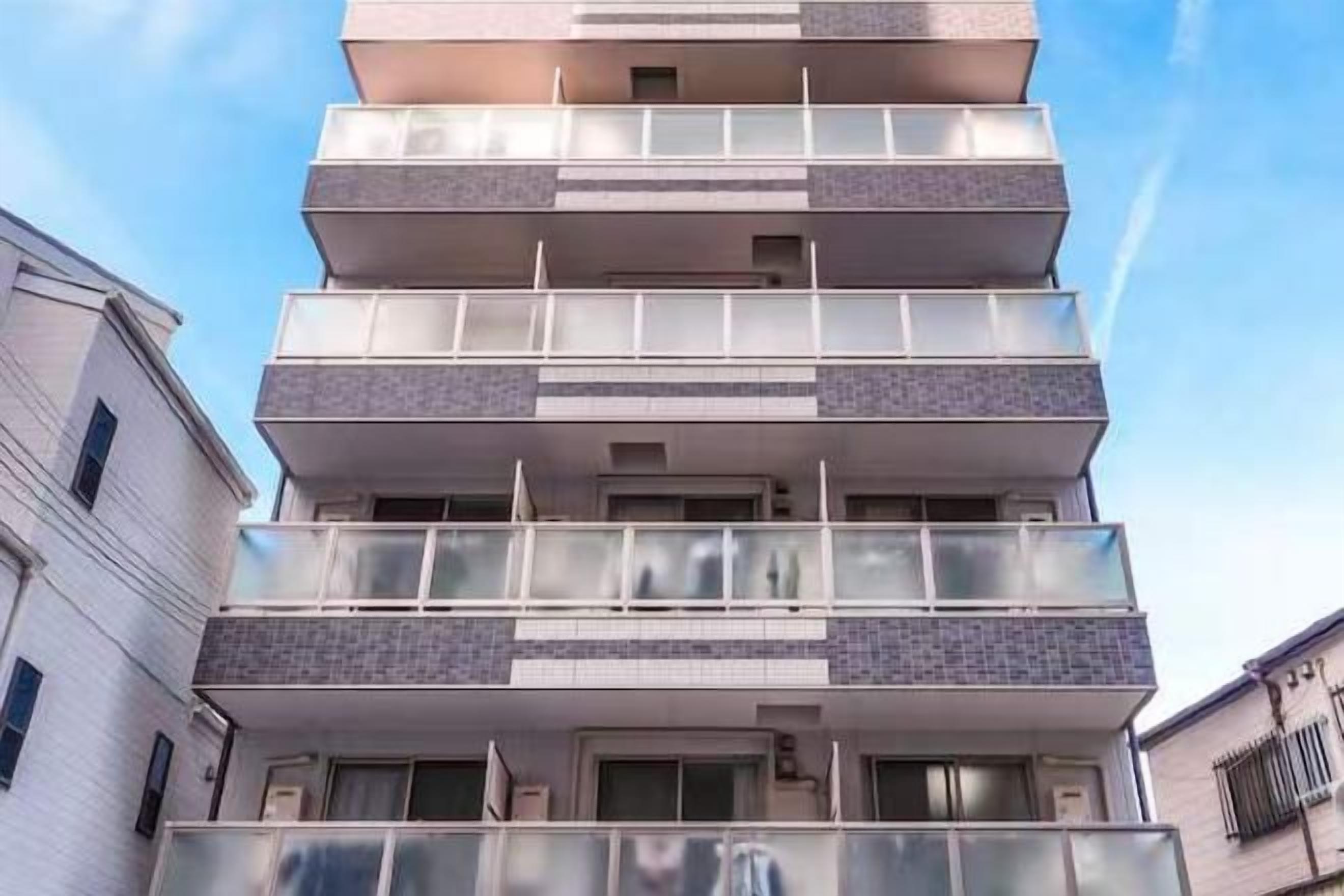 A multi-story building with balconies and windows.