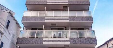 A multi-story building with balconies and windows.