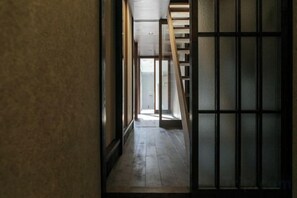 A narrow corridor with wooden flooring and a traditional sliding door. - Trive Kamejima (Nagoya)