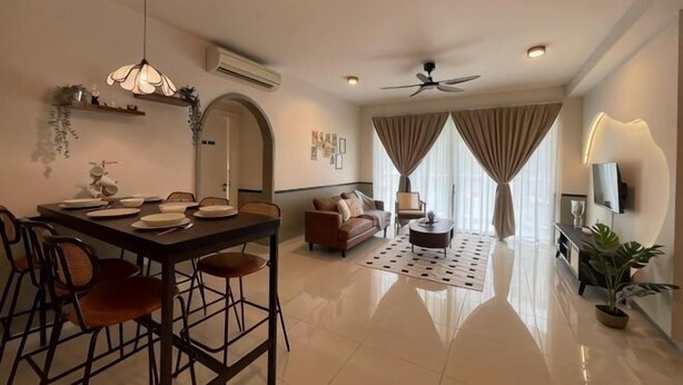 A modern living room with a dining area, a ceiling fan, and a TV. - NEW Serenity@Teega ResidenceL2 by UcomeHomestay (Iskandar Puteri)
