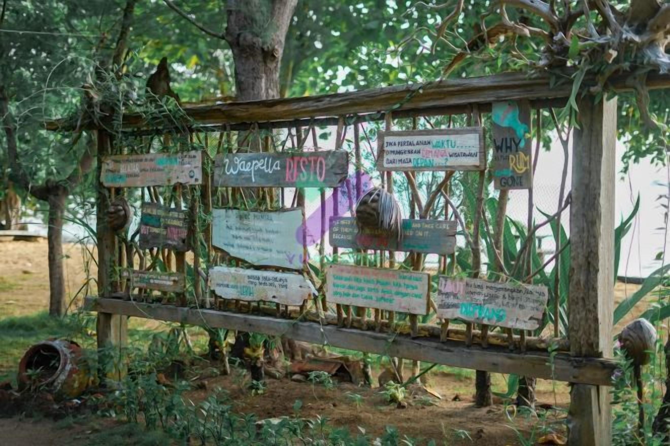 A wooden signpost with multiple directional signs in a natural setting.