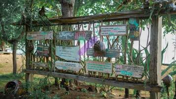 A wooden signpost with multiple directional signs in a natural setting.
