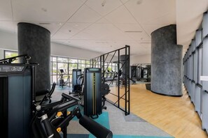 A gym with exercise equipment, large windows, and a modern design. - Datum Jelatek Residence by FEEL HOME (Ampang)