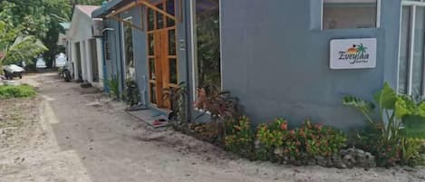 A building with a sign reading 'Everyla' and a dirt path leading to it.