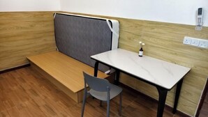A small, private workspace with a desk, chair, and a cushioned bench. - Evelyaa Guest House (Fulidhoo)