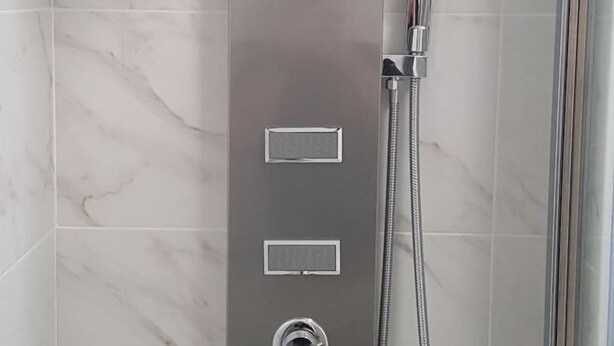 A modern shower enclosure with a control panel and a handheld showerhead. - E&E Apartments Free Parking / Sports Arena LJ (Bezigrad District)