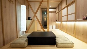A room with tatami flooring, a black rectangular table, and cushions. - WATEL ASAKUSA (Tokyo)