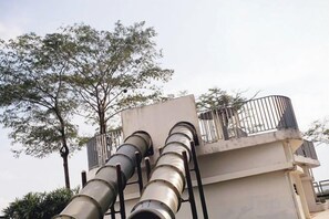 A building with a balcony and a large cylindrical structure. - Delight Homestay Mosaic Southkey (Plentong)