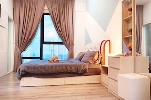A modern bedroom with a bed, curtains, a window, and a built-in bookshelf.