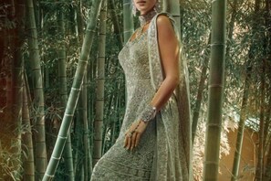 A person in a patterned dress standing in a bamboo forest. - Iidaya Hotel (Yokohama)
