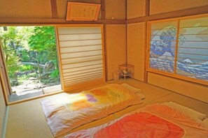 A traditional Japanese room with tatami flooring, sliding doors, and shoji screens. - Iidaya Hotel (Yokohama)