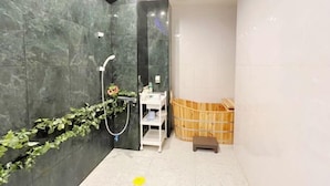 A modern bathroom with a shower, a wooden bench, and a small step stool. - MIIYAVI Hotel (Tokyo)