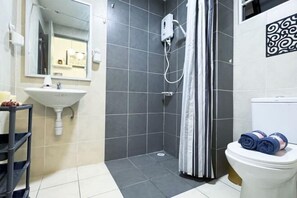 A bathroom with a sink, mirror, shower, toilet, and towel rack. - Pool View Air-Con Studio @Tiara Imperio Bangi (Kajang)