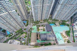 A high-rise residential building with multiple floors, a central courtyard, and surrounding greenery. - An Corner Apt - Vinhomes Central Park High Floor Nice View and Free Pick up for 5 Nights (Ho Chi Minh City)