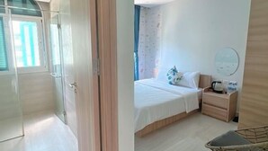 A bedroom with a bed, bedside table, and a chair. - Nhà Nguyên Căn Costis 5 Phòng Ngủ (Phu Quoc Island)