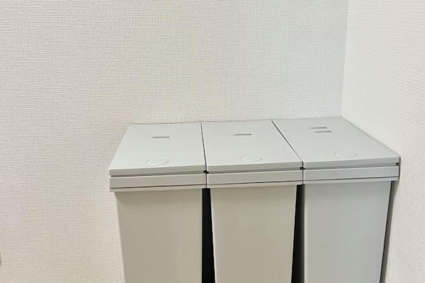 A white trash bin with three compartments. - YMK Oshiage 5B (Tokyo)