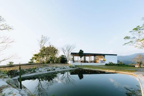 A modern house with a pool, surrounded by trees and a clear sky. - Akano Doichang (Mae Suai)