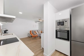 A modern kitchen with a built-in microwave, oven, and refrigerator.