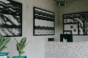 A room with abstract wall art, a potted plant, and a patterned cabinet. - T Lofts (Bali)