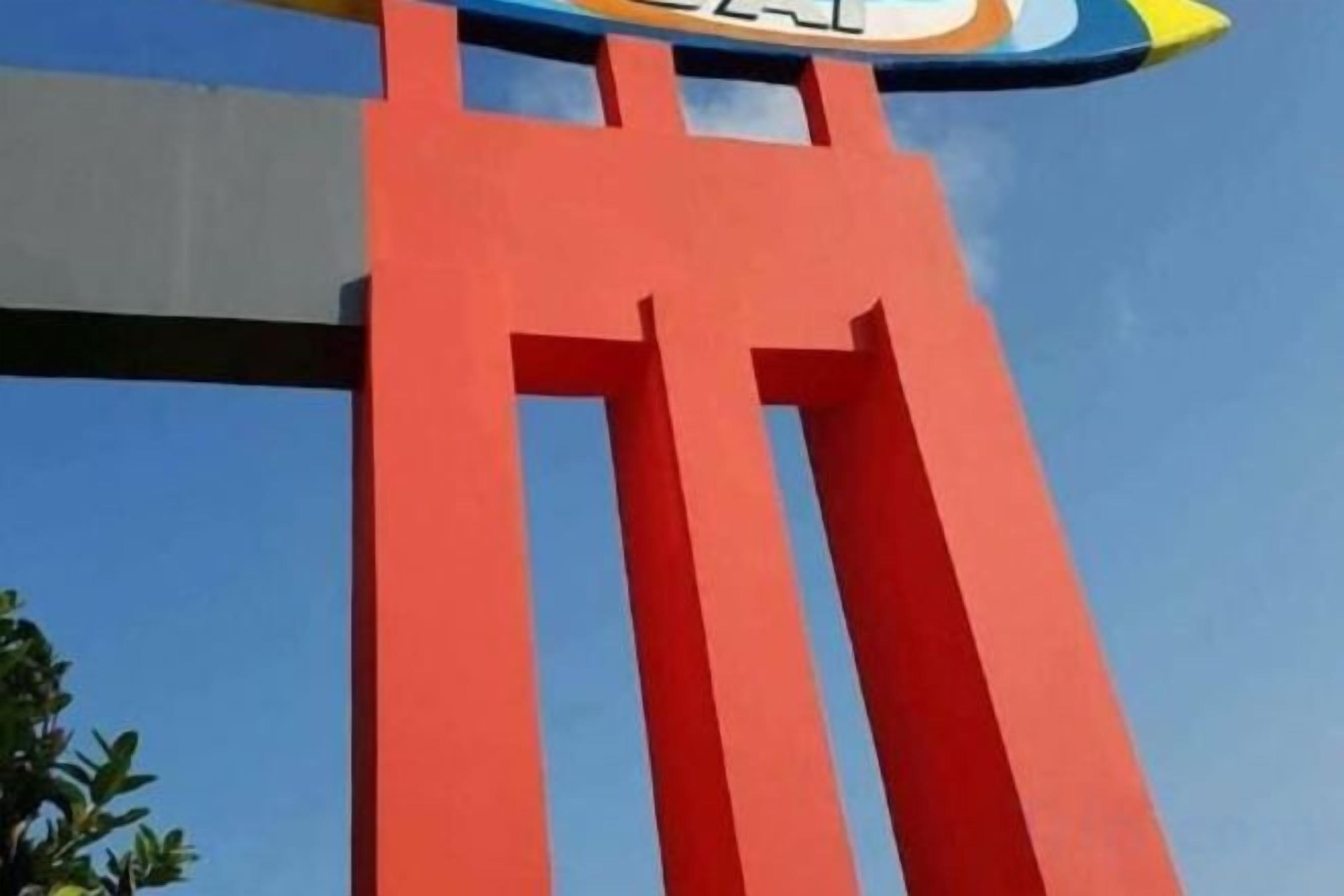 A red structural element, possibly part of a building's facade.